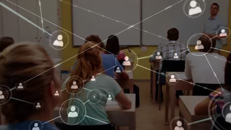 Animation-of-network-of-connections-with-icons-over-male-teacher-and-students