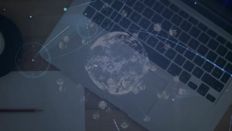 Animation-of-globe-with-network-of-connections-with-glowing-spots-over-laptop