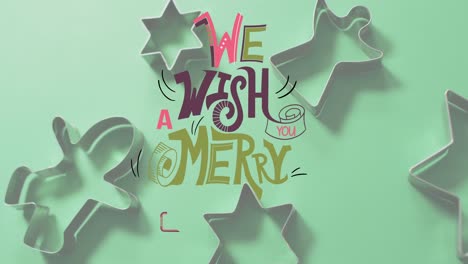 Animation-of-merry-christmas-text-over-cookie-cutters