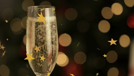 Animation-Von-Sternen,-Die-über-Einem-Glas-Champagner-Auf-Schwarzem-Hintergrund-Schweben