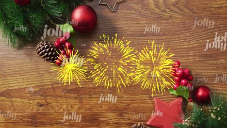 Animation-of-jolly-text-in-repetition-and-fireworks-over-christmas-decorations