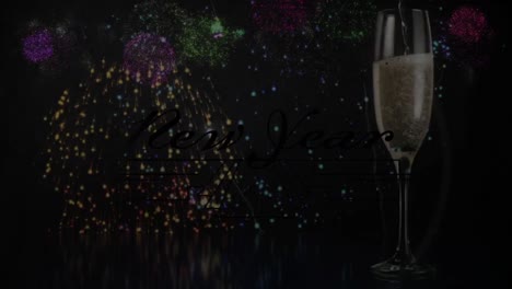 Animation-of-happy-new-year-greetings-over-fireworks-and-glass-of-champagne
