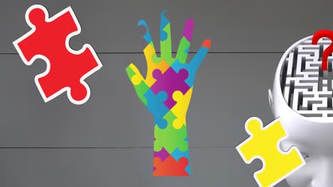 Animation-of-autism-awareness-month-colourful-puzzle-pieces-forming-hand-and-brain-with-maze