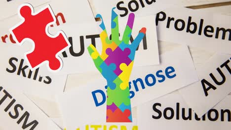 Animation-of-colourful-puzzle-pieces-and-autism-awareness-month-text