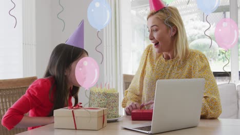 Animation-Von-Luftballons-über-Einer-Glücklichen-Mutter-Und-Tochter-Mit-Kuchen,-Die-Einen-Laptop-Videoanruf-Zum-Geburtstag-Backen