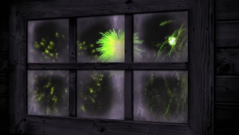 Animation-of-window-with-green-christmas-and-new-year-fireworks-exploding-in-night-sky