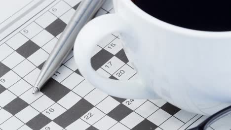 Animation-of-crossword-puzzle,-pen,-glasses-and-cup-of-coffee