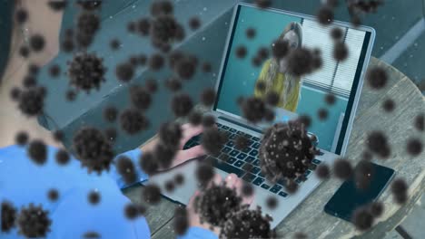 Animation-of-covid-19-cells-over-businesswoman-on-laptop-video-call