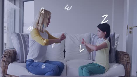 Animation-of-letters-over-caucasian-woman-and-her-daughter-wearing-face-masks-using-sign-language