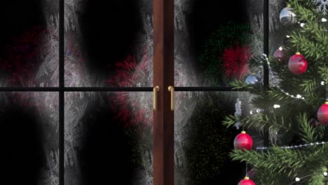 Animation-of-window-with-snow-and-christmas-tree-and-fireworks-in-night-sky