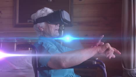 Animation-of-blue-light-moving-over-smiling-senior-caucasian-woman-in-wheelchair-using-vr-headset