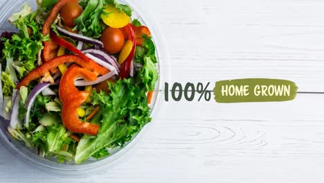 Animation-of-100-percent-home-grown-text-in-green-over-fresh-organic-vegetable-salad-in-bowl-on-wood