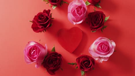 Red-and-pink-roses-with-heart-on-red-background-at-valentine's-day