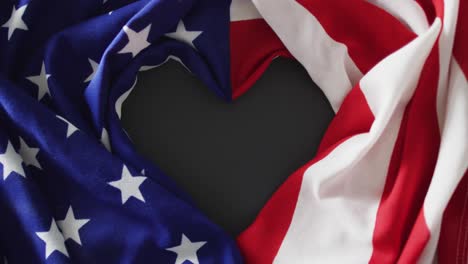 Crumpled-american-flag-with-heart-shape-and-stars-and-stripes-lying-on-gray-background