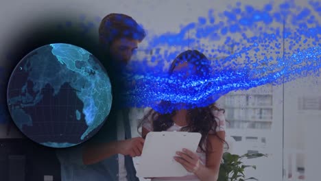 Animation-of-global-network-and-blue-particles-processing-data-over-man-and-woman-at-work-in-office