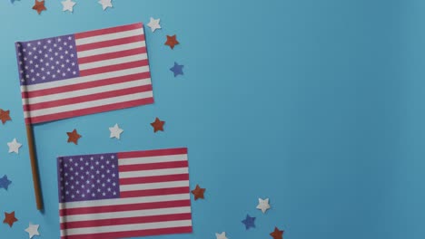 American-flags-with-red-and-blue-stars-lying-on-blue-background
