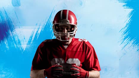 Animation-of-american-football-player-holding-ball-on-abstract-painted-blue-background