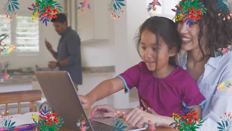 Animation-of-colourful-flowers-over-smiling-mother-and-daughter-using-laptop-together-at-home