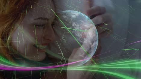 Animation-of-globe-and-light-trails-over-caucasian-businesswoman-using-smartphone