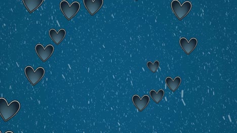 Animation-of-hearts-moving-over-snow-falling-on-blue-background