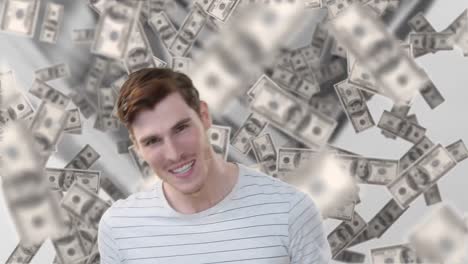 Animation-of-american-dollar-bills-floating-over-smiling-caucasian-man