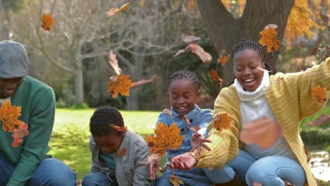 Animation-of-autumn-leaves-falling-over-happy-african-american-family-in-park