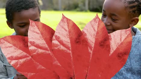 Animation-of-autumn-leaves-falling-over-happy-african-american-boy-and-girl-in-park