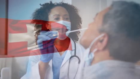 Animation-Der-Flagge-Der-Schweiz-Mit-Ärztin-In-Gesichtsmaske,-Die-Einen-Männlichen-Patienten-Auf-Covid-Testet
