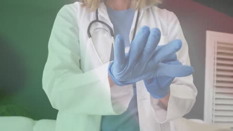 Animation-of-flag-of-italy-with-midsection-of-female-doctor-putting-on-surgical-gloves