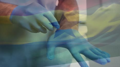 Animation-of-flag-of-ghana-with-male-doctor-putting-on-surgical-gloves