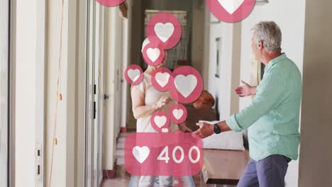 Animation-of-social-media-heart-icons-with-numbers-over-senior-couple-dancing