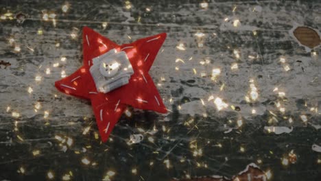 Animation-of-confetti-falling-over-christmas-decoration-of-red-star-on-wooden-background