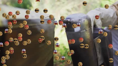 Animation-of-emojis-floating-over-beekeeper-smoking-beehive