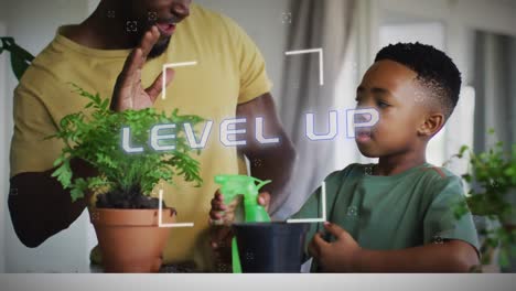 Animation-of-level-up-text-in-white-over-happy-african-american-father-and-son-high-fiving-at-home