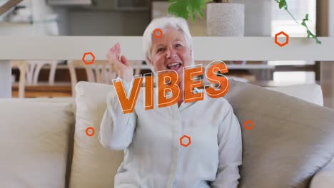Animation-of-vibes-text-in-orange-over-happy-caucasian-woman-making-video-call-at-home