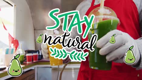 Animation-of-stay-natural-text-over-food-vendor-serving-health-drinks-to-customer