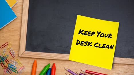 Animation-of-keep-your-desk-clean-text-on-memo-note-on-chalkboard-on-desk