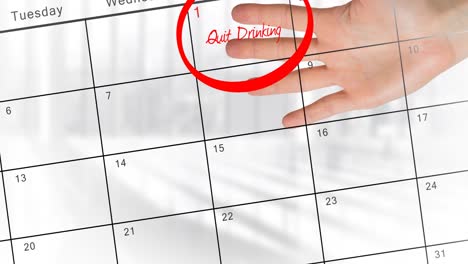 Animation-of-quit-drinking-in-red-text-and-red-ring-on-january-1st-on-calendar,-with-hand