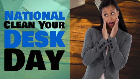 Animation-of-national-clean-your-desk-text-over-worried-businesswoman-and-wooden-background