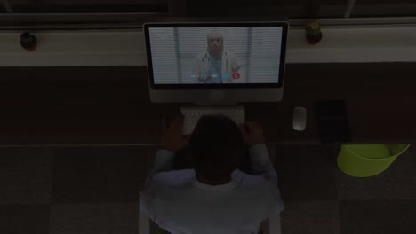 Animation-of-light-trails-over-african-american-businessman-having-laptop-video-call-with-doctor