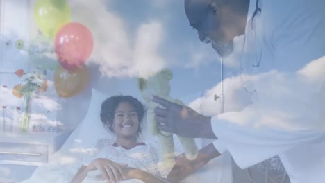 Animation-of-clouds-over-happy-african-american-doctor-playing-with-female-patient-lying-in-hospital