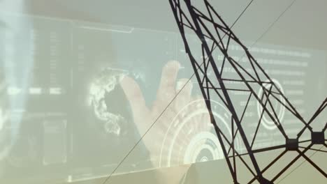 Animation-of-hand-touching-digital-screen-with-data-processing-over-electricity-pylon