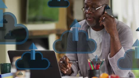 Animation-of-clouds-with-arrows-over-african-american-man-talking-on-smartphone