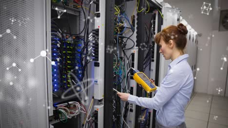 Animation-of-shapes-moving-over-caucasian-female-worker-inspecting-server-room