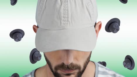Animation-Eines-Kaukasischen-Mannes-Mit-Mütze-über-Fallenden-Hüten-Auf-Weißem-Hintergrund