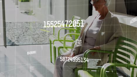 Animation-of-numbers-and-data-processing-over-senior-caucasian-woman-in-doctor's-waiting-room
