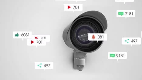 Animation-Von-Social-Media-Symbolen-Und-Zahlen-über-Einer-Überwachungskamera