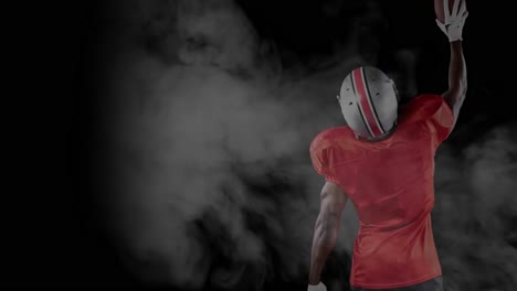 Animation-of-smoke-over-male-american-football-player-with-ball