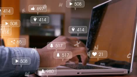 Animation-of-social-media-icons-and-numbers-over-hands-of-african-american-man-using-laptop