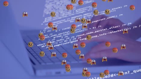 Animation-of-floating-emojis-over-data-processing-and-hand-writing-on-laptop